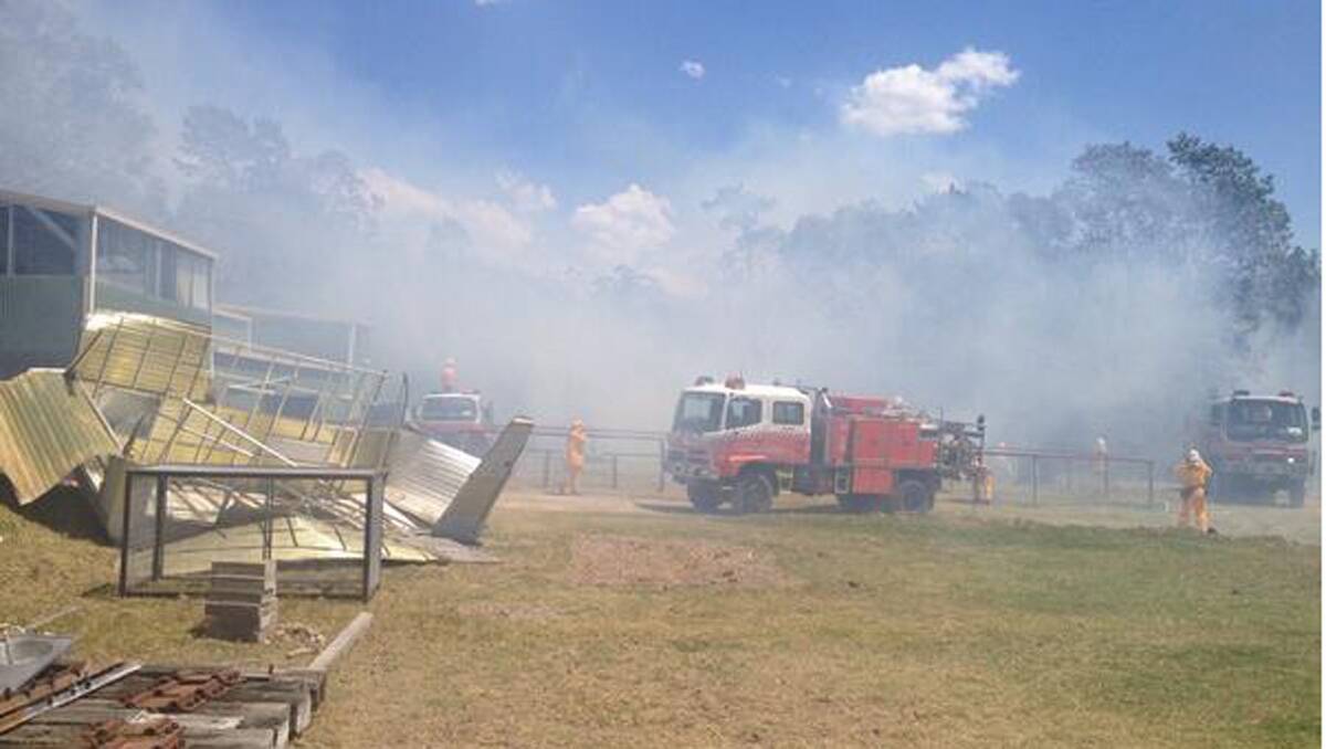 BATTLE CONTINUES: Firefighters get on top of the fire at Dog Hole Road - a dirt track near Minmi - with the aid of water bombing. (Nat Wallace, NBN, via Twitter) 