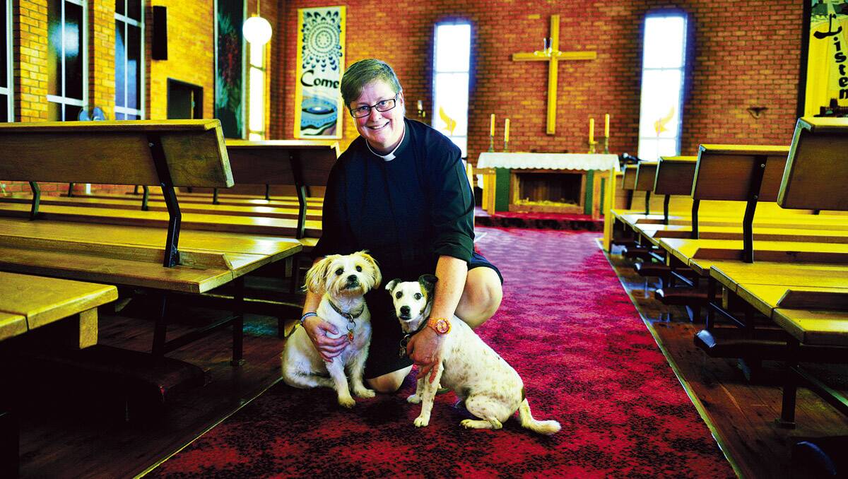 GOD'S CALL: Mother Moira, 46, is the new priest of the Anglican Parish of Telarah Rutherford, pictured with her "fur babies" Ambrose and Brigid.