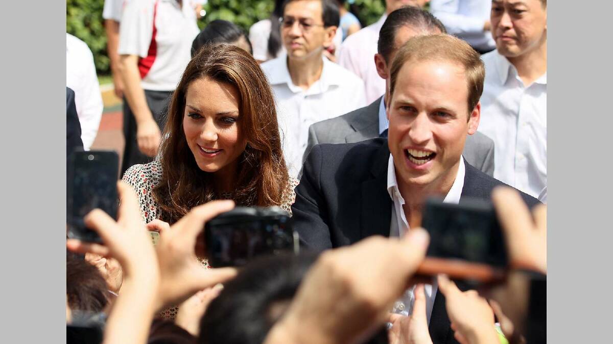 Prince William, Duke of Cambridge and Catherine, Duchess of Cambridge greet fans during a visit to the Strathmore Green residential district while in Singapore in September. Picture: Getty Images