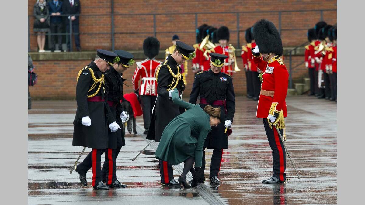 Catherine, Duchess of Cambridge is helped by Prince William, Duke of Cambridge as she gets her heel stuck in the grating while they take part in a St Patrick's Day parade. Picture: Getty Images