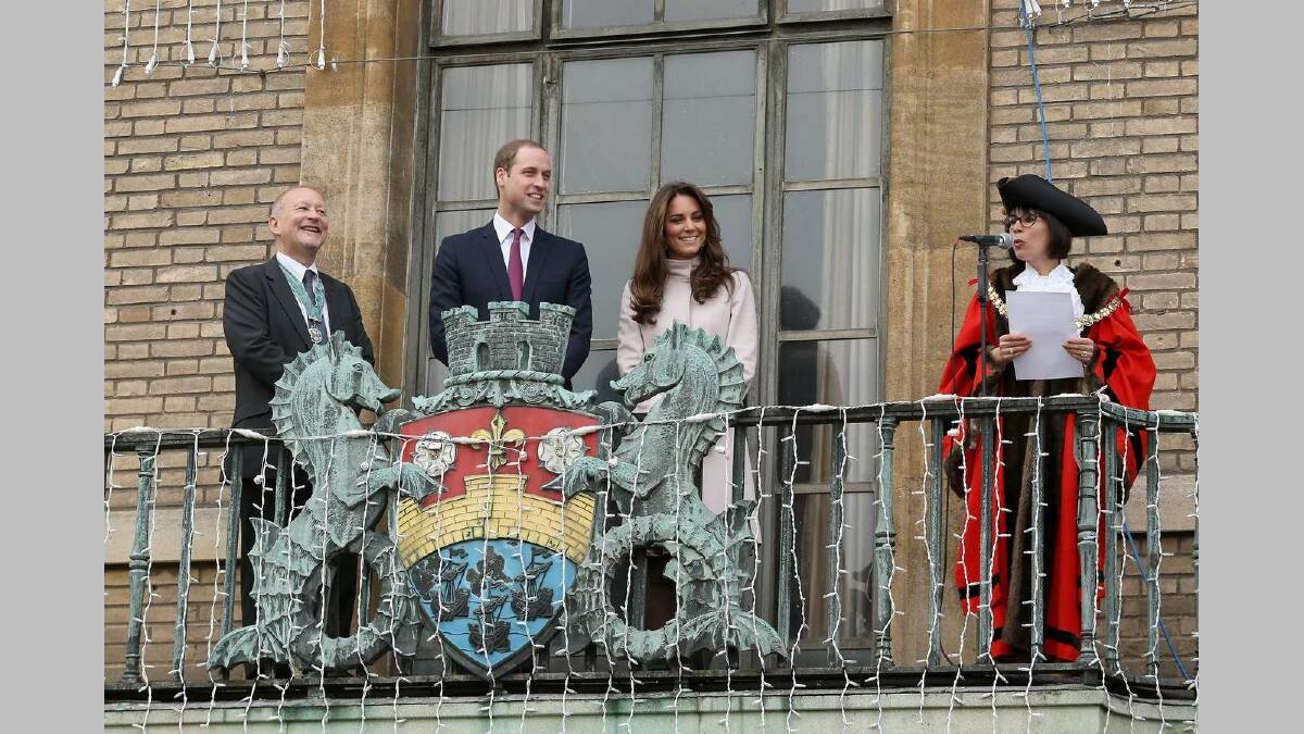 Catherine, Duchess of Cambridge and Prince William, Duke of Cambridge smile and wave to the crowds from the balcony of Cambridge Guildhall as they pay an official visit in November 28. Picture: Getty Images