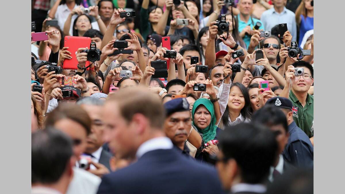 Members of the public take photographs as Catherine, Duchess of Cambridge and Prince William, Duke of Cambridge attend a cultural event on day 4 of Prince William, Duke of Cambridge and Catherine, Duchess of Cambridge's Diamond Jubilee Tour of the Far East on September 14, 2012 in Kuala Lumpur, Malaysia. Picture: Getty Images