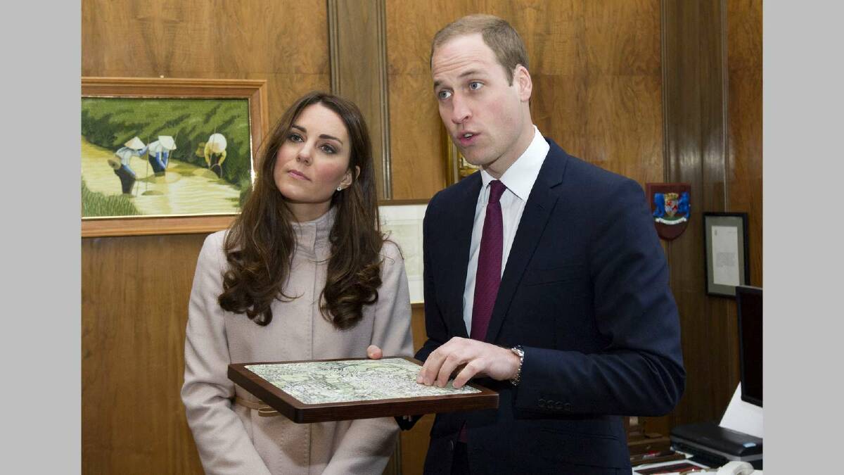 Prince William, Duke of Cambridge and Catherine, Duchess of Cambridge receive a gift during an official visit to the Guildhall on November 28, 2012 in Cambridge. Picture: Getty Images