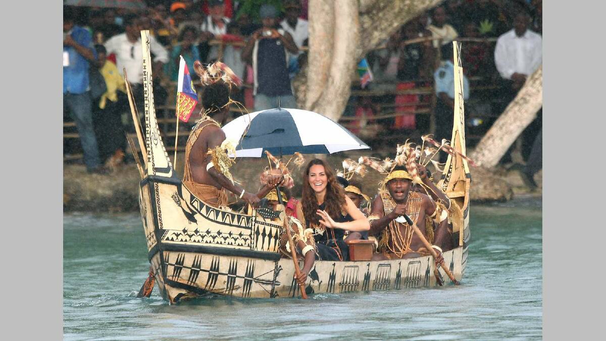 Catherine, Duchess of Cambridge and Prince William, Duke of Cambridge are followed by locals dressed as 'sharks' as they travel into Honiara in the Solomon Islands. Picture: Getty Images