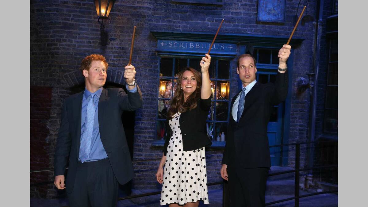  Prince Harry, Catherine, Duchess of Cambridge and Prince William, Duke of Cambridge raise their wands on the set used to depict Diagon Alley in the Harry Potter films on April 26, 2013. Picture: Getty Images