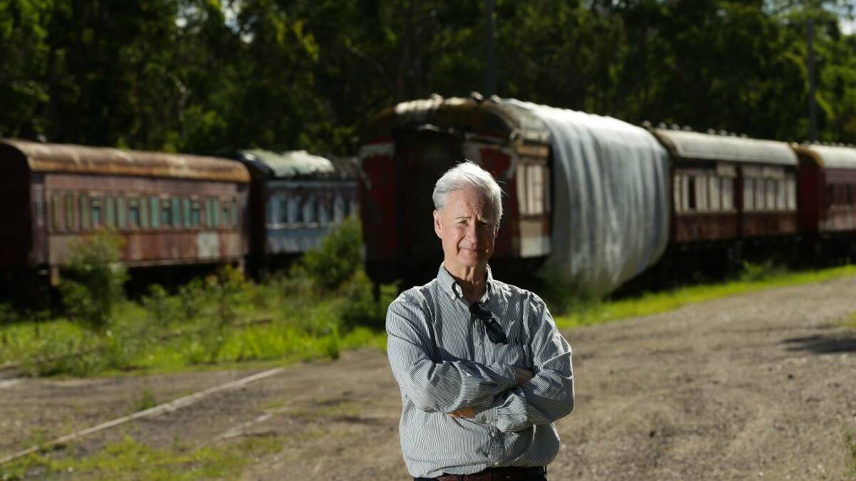 STILL BATTLING: Chris Richards, head of the Hunter Valley Railway Trust, with trains that must now be removed from Huntlee land at North Rothbury.