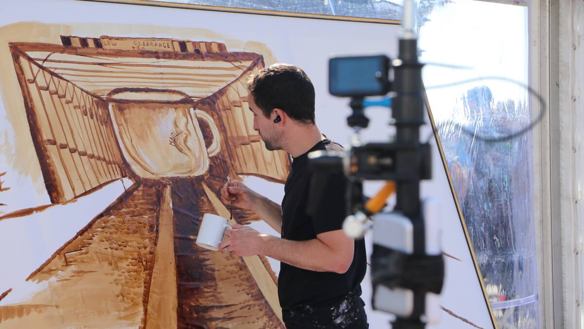 James Patrick painting his live coffee art at Maitland Aroma. Picture supplied