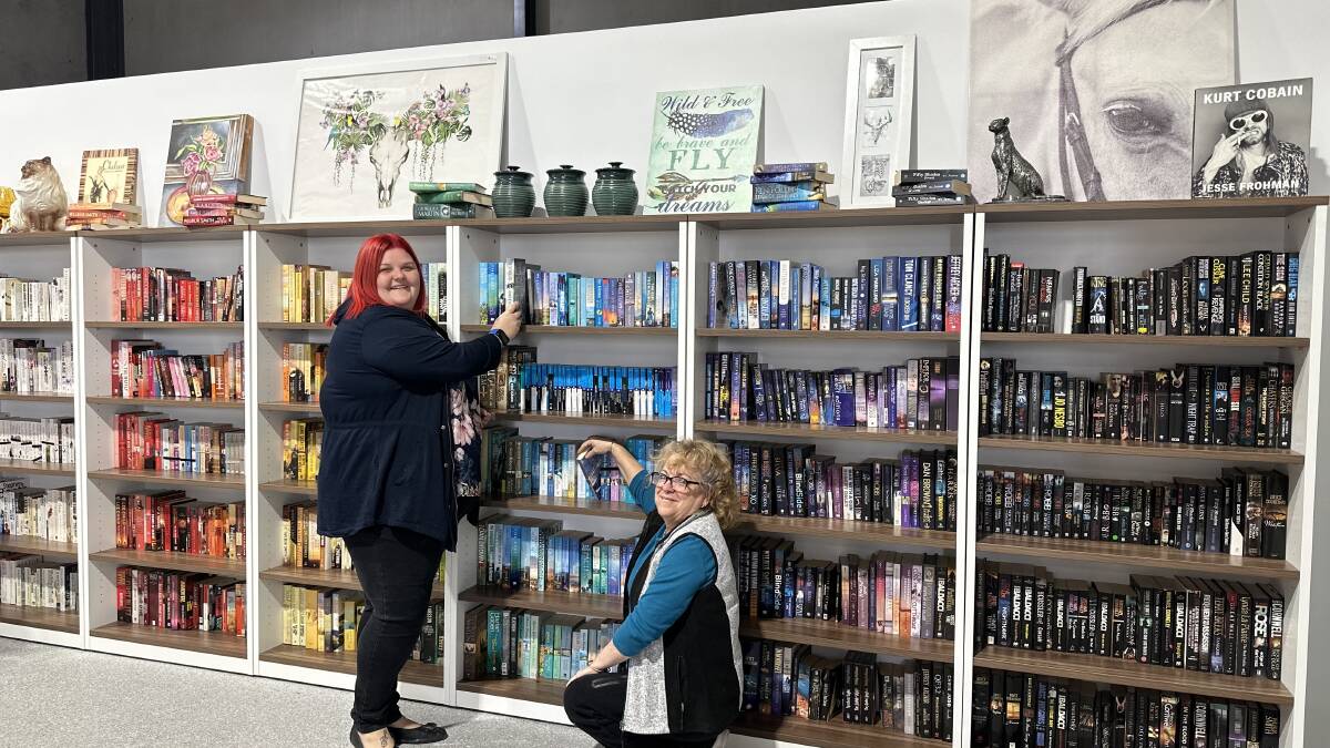 Lifeline shop managers Ashlea Evans from Raymond Terrace and Bronwyn Strickland from Cardiff helping set up the new Rutherford shop. Picture supplied.