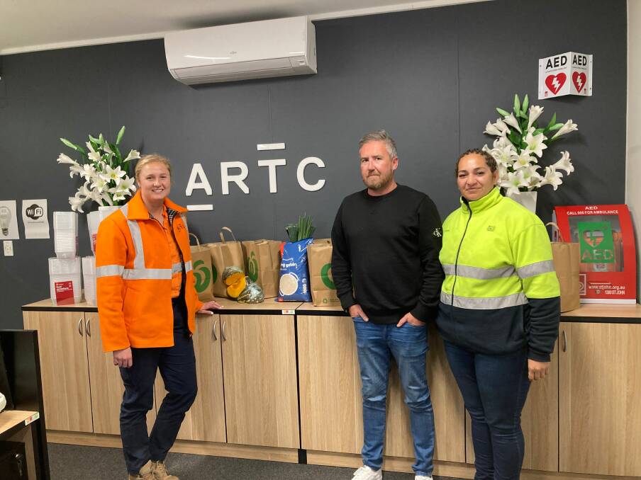 ARTC Rutherford area manager maintenance services Tara Andrews with Hunter Food Relief Centre secretary Mathew Johnston and director Georgina Grine. Picture supplied