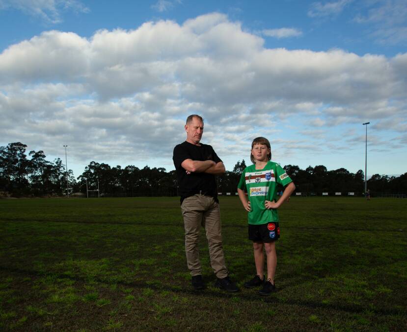 CALL FOR ACTION: Stephen Drinkwater and his son, Joshua at Shamrock Oval where Joshua plays for the East Maitland Griffins. Stephen is taking on a 100km row on Friday to highlight the drainage issue. Picture: Jonathan Carroll