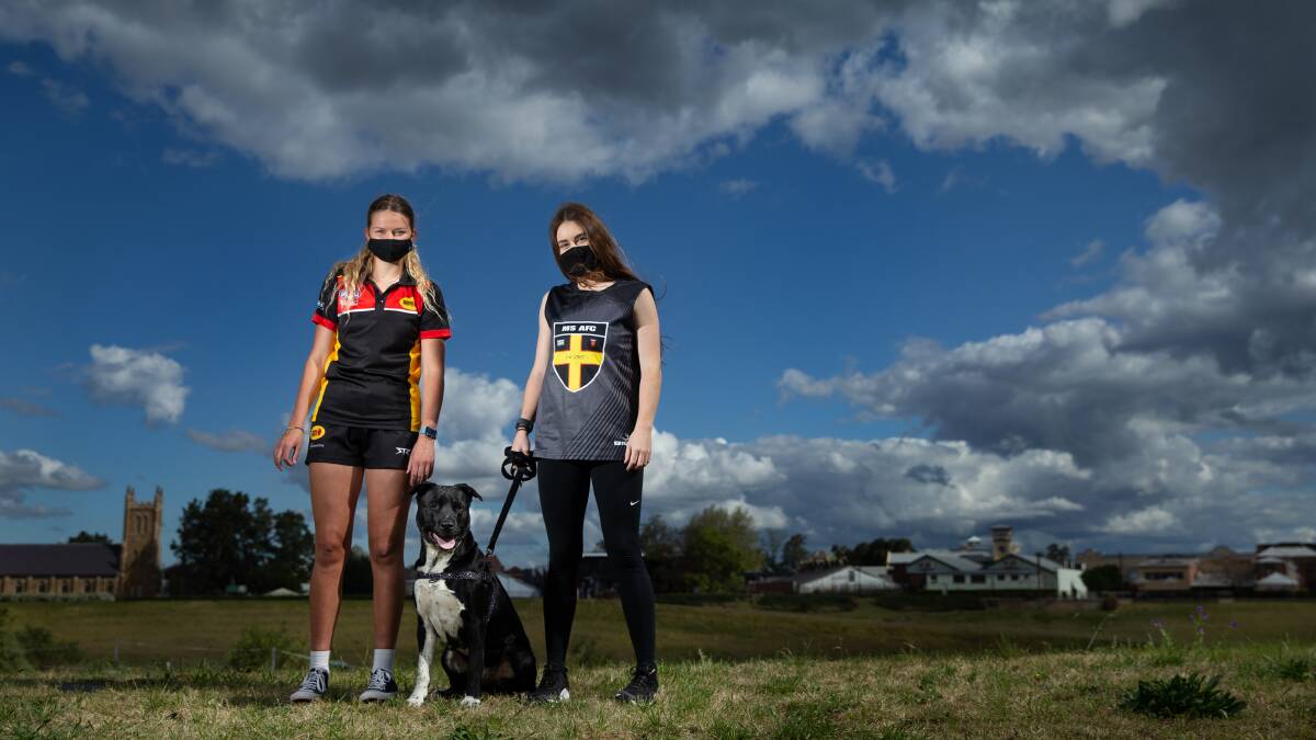 Walking for a cause: Maitland Saints AFL players Stella Nichols and Skyla Dunn with Neddy. PHOTO: Marina Neil.