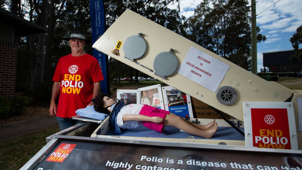 Rotary Club of East Maitland past president Brian Morgan with an iron lung. Picture by Marina Neil
