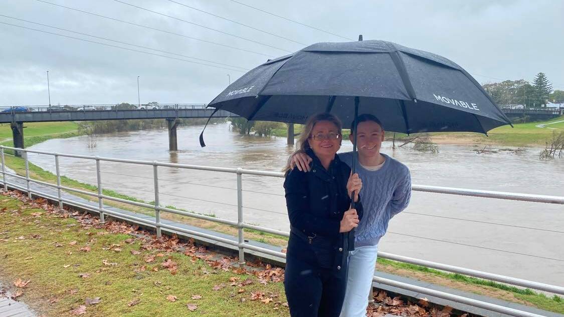 WET: Bridgette and Lucy Greaves from Tenambit have been watching the river rise. Picture: Michael Hartshorn.
