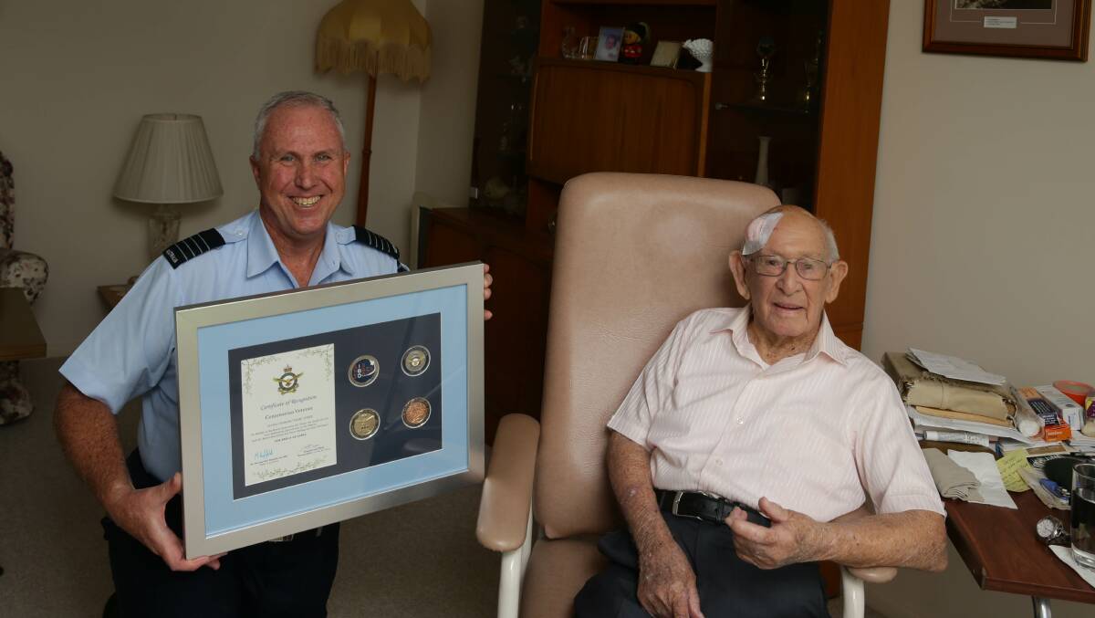 RECOGNITION: RAAF Base Williamtown Group Captain Anthony Stainton presented veteran World War II Spitfire pilot Clem Jones with the Centenarian Veteran Certificate of Recognition and medals ahead of his 101st birthday. Picture: Jonathan Carroll.