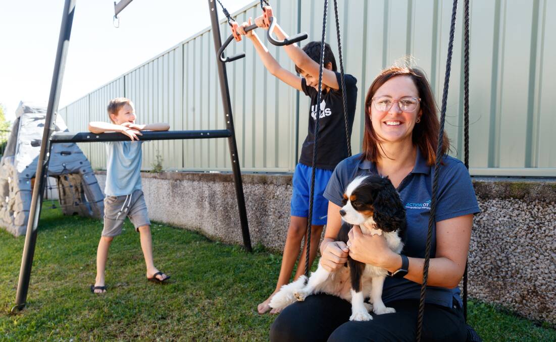 FAMILY TIME: Nikki's three sons volunteer alongside her at East Maitland Rotary Club. Two of her sons, Archie and Dexter, are pictured here with Nikki and the family dog, Evie. Picture: Max Mason-Hubers.