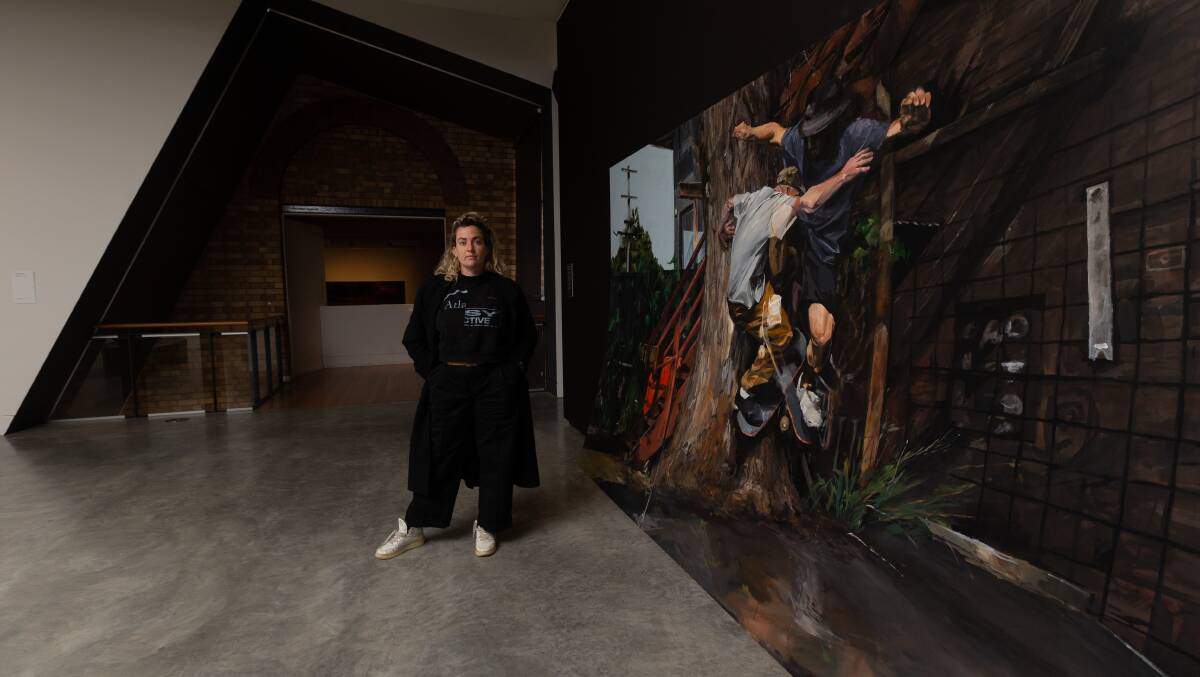 Newcastle artist Brontë Naylor with her work Muscle Memory, which is on exhibition in Maitland Regional Art Gallery as part of Upriver, Downriver. Picture by Jonathan Carroll