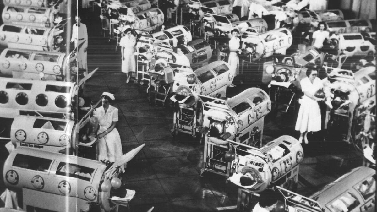 Iron lung respirators being used to help simulate breathing for polio patients. 