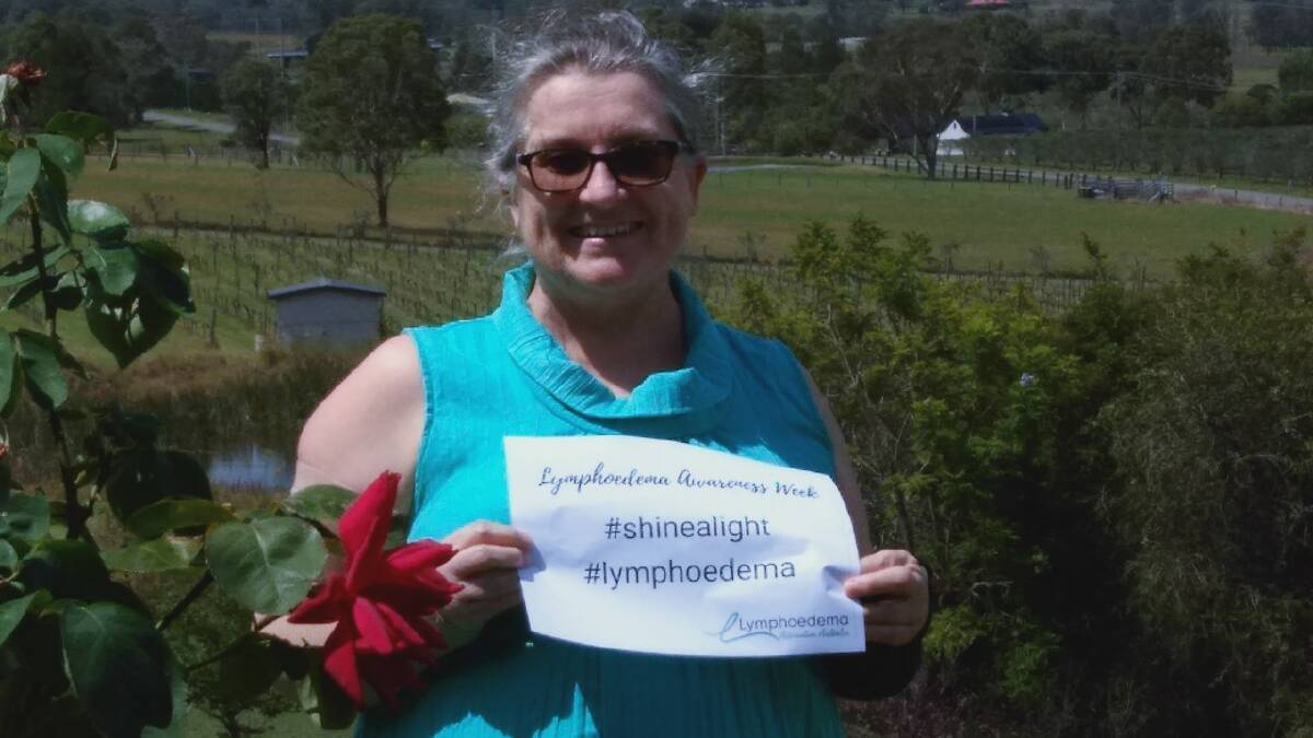 Sally Keir with lymphoedema awareness signage. Picture supplied.