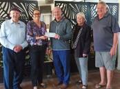 HELPING HAND: President of EMBC Bill Hopkins (left) and CEO Steve Duggan (middle) with representatives of Coraki Memorial Bowling Club, most of which is still closed because of the damage. Picture: Supplied.
