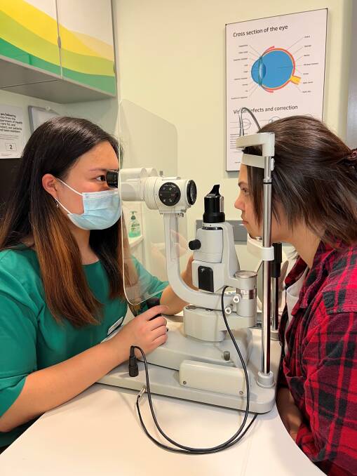 Optometrist Anne Zhang performing an eye test at Specsavers Green Hills, East Maitland. Picture supplied.