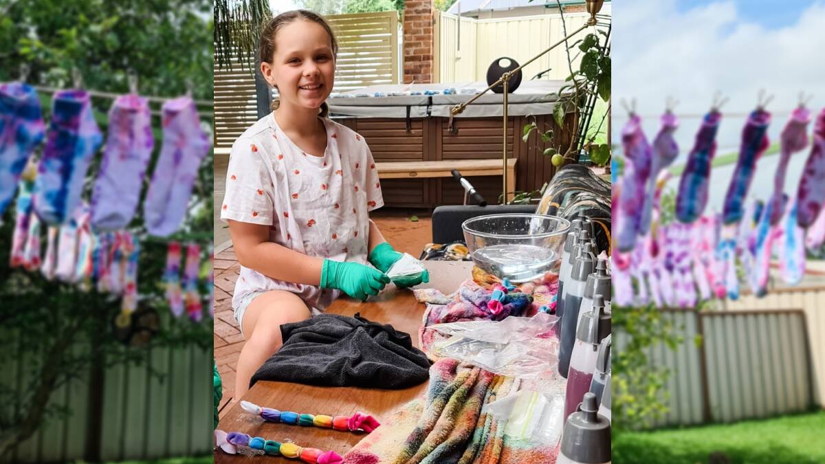 TAKING ACTION: Hallie has been hard at work tie-dying socks to raise money for flood victims. Picture: Supplied.