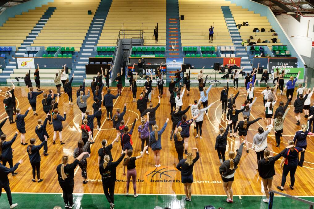 Huge task: 120 high school students practise their Star Struck routine at Newcastle Basketball Stadium. Picture: Max Mason-Hubers