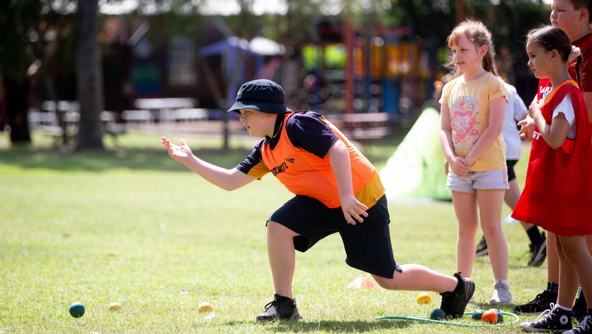 Largs Public School student Elliott Dawson tries his hand at pétanque. Picture by Jonathan Carroll