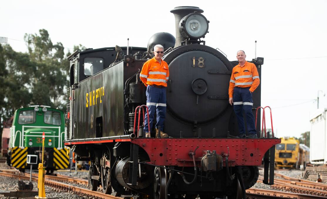 Peter Tippett (left) and Warren Hedley have made sure the No.18 steam locomotive is in pristine condition for the 40th anniversary celebration on Sunday. Picture by Jonathan Carroll