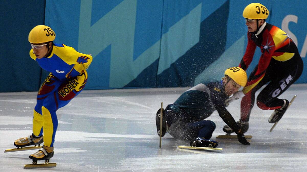 Steven Bradbury collides with Andre Hartwig of Germany in the fourth heat of the men's 1500 meter short track speed skating race at the 2002 Winter Olympics in Salt Lake City. (AP Photo/Lionel Cironneau)