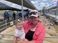 Jess Pittman with her daughter Maggie, 10 months, Wahnica, Loomberah, accepted the second place award on behalf of her family for the heavyweight pen of lambs at the Tamworth Livestock Selling Agents Association Autumn Lamb Show and Sale on Monday. Picture by Simon Chamberlain.