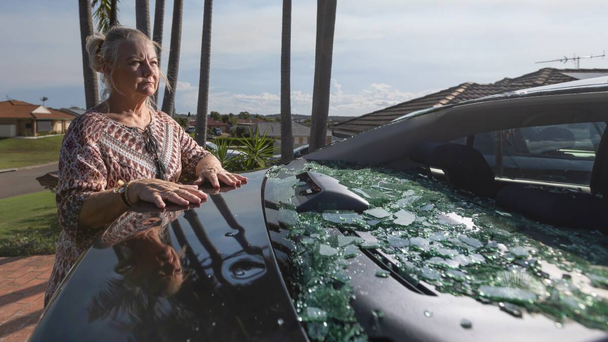 Tanya Budynek with her smashed car windscreen in Rutherford. Picture by Marina Neil