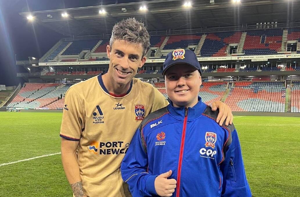 Hunter Ward with his favourite player, Newcastle Jets games-record holder Jason Hoffman after a match earlier this year. Picture supplied