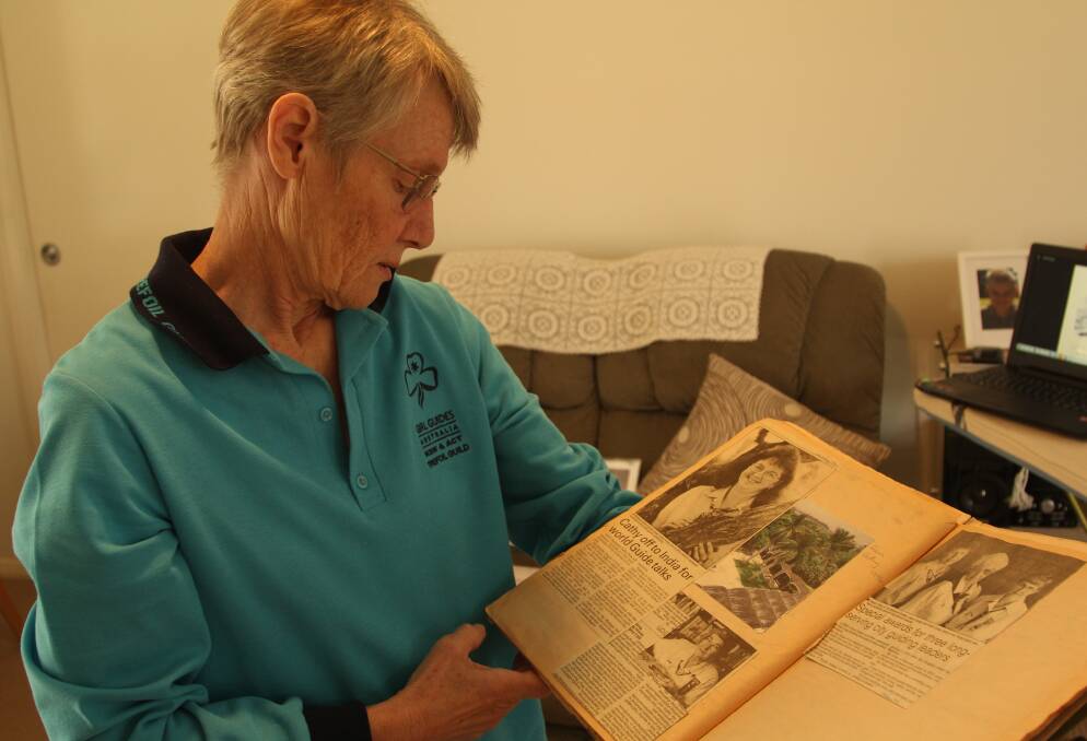 Historian and former Guide leader Sue Folpp looks over some of the collection which will be displayed as part of the 100 year centenary of girl guiding in Maitland. Picture by Ben Carr