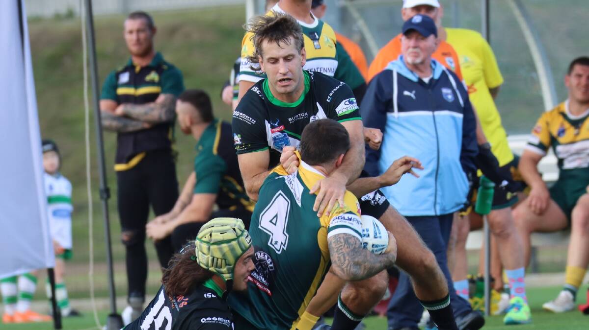Gary Anderson, left, and James Bradley from the Maitland Pickers tackle Macquarie Scorpions centre Royce Geoffrey at Maitland No 1 Sportsground on Saturday, May 13. Picture by Jenny's Sports Photography