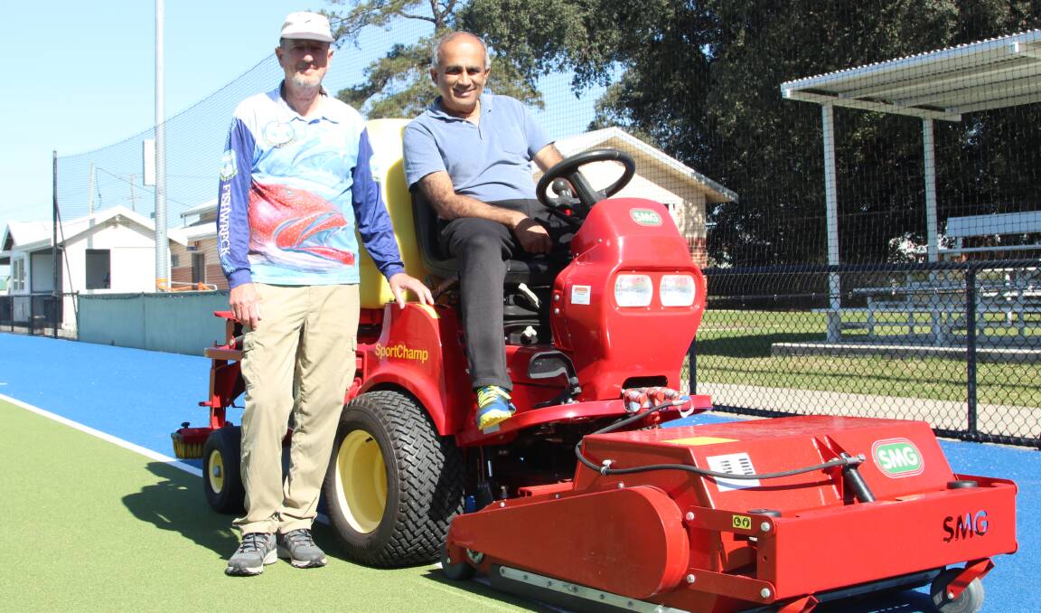 Bill Kinsey, left, and Murali Nagarajan after completing their Tuesday morning maintenance work at Maitland Hockey Turf. Picture by Ben Carr