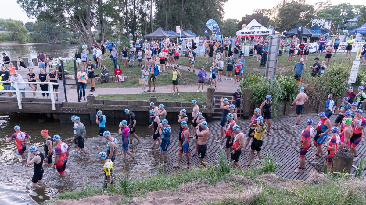 Athletes gather at Queens Wharf in Morpeth ahead of the start of the Maitland Triathlon. Picture by Lee Piggott