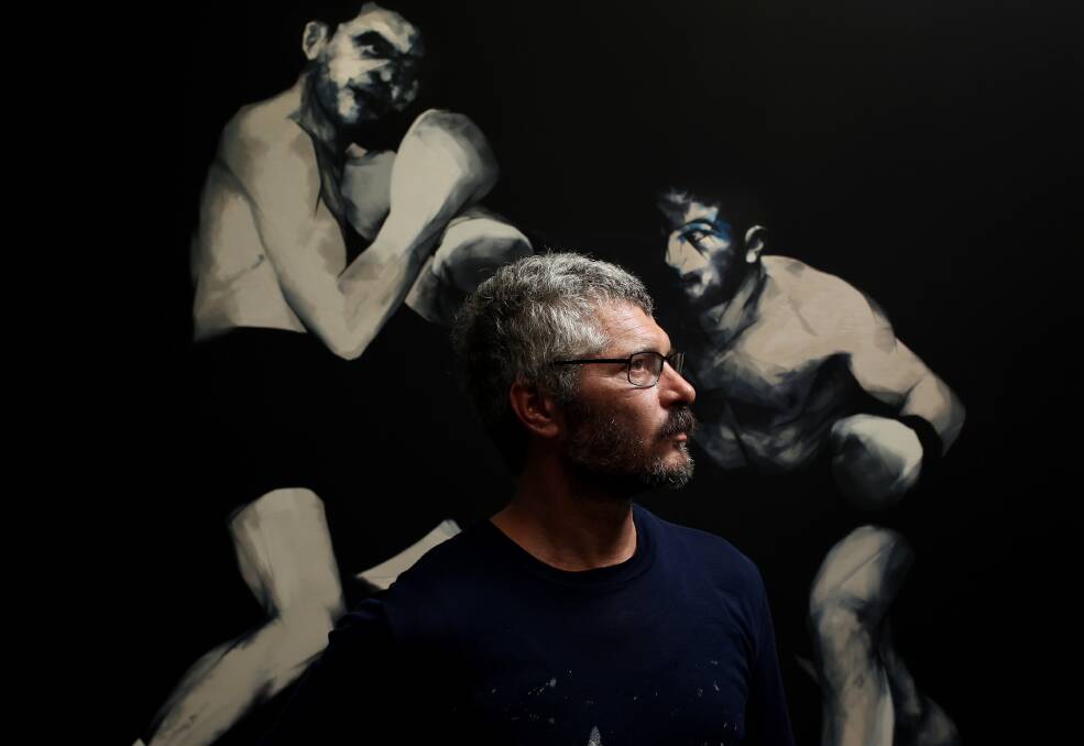 New work: Newcastle artist Nigel Milsom with one of his five new boxing artworks. Picture: Simone De Peak