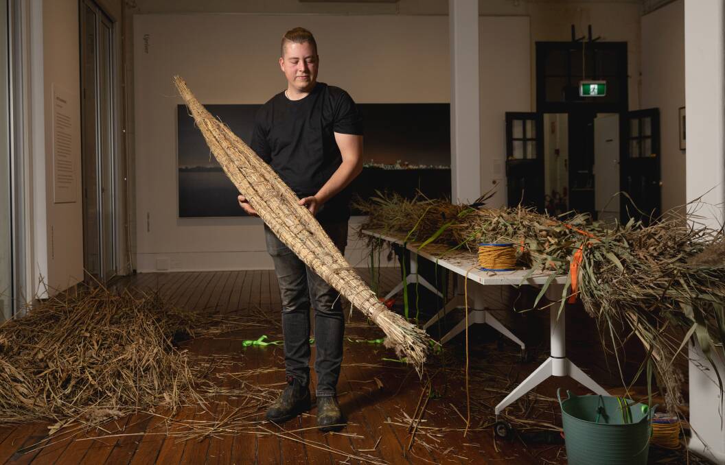 Mitch Mahoney showing how a river reed canoe is made in 2023 at Maitland Regional Art Gallery. Picture by Marina Neil