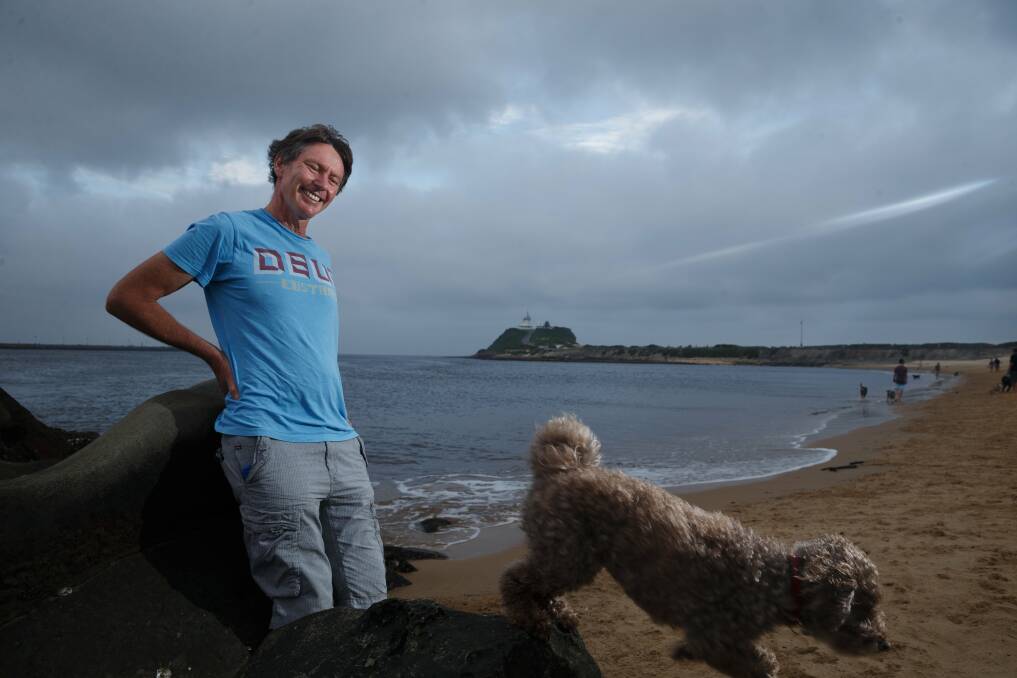 Michael Bell at Newcastle's dog beach with his dog Larry in 2016. Picture by Max Mason-Hubers 