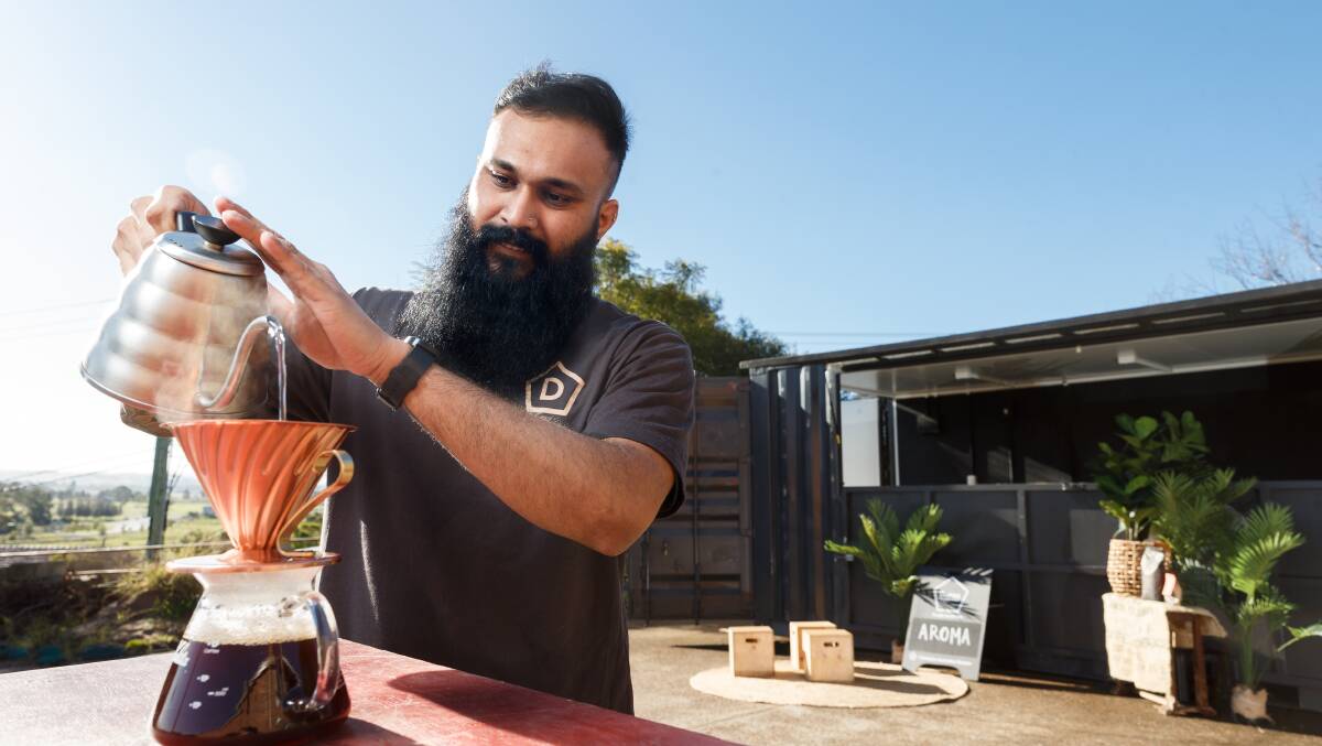 COFFEE: Kunaal Singh from Danes Specialty Coffee with shipping container where the pop-up coffee lab will be held. Picture: Max Mason-Hubers 