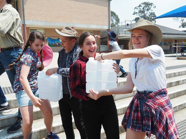 DONATE: Maitland Christian School students formed a production line to package more than five tonnes of water for drought affected farmers.