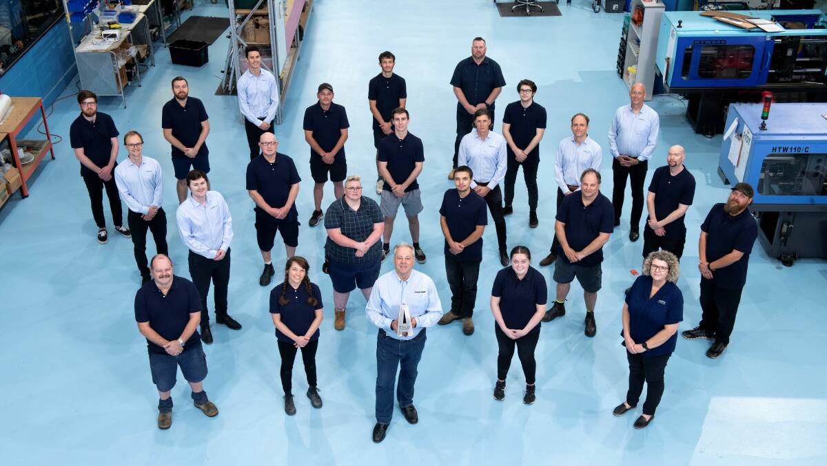 Omnia Managing Director Peter McKinnon (front centre) with staff at its Beresfield manufacturing centre.