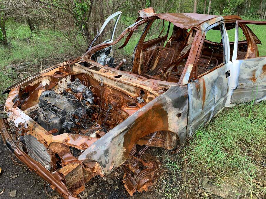 ABANDONED: A burnt-out car among other debris litter the Metford site. Picture: Mitchell Griffin