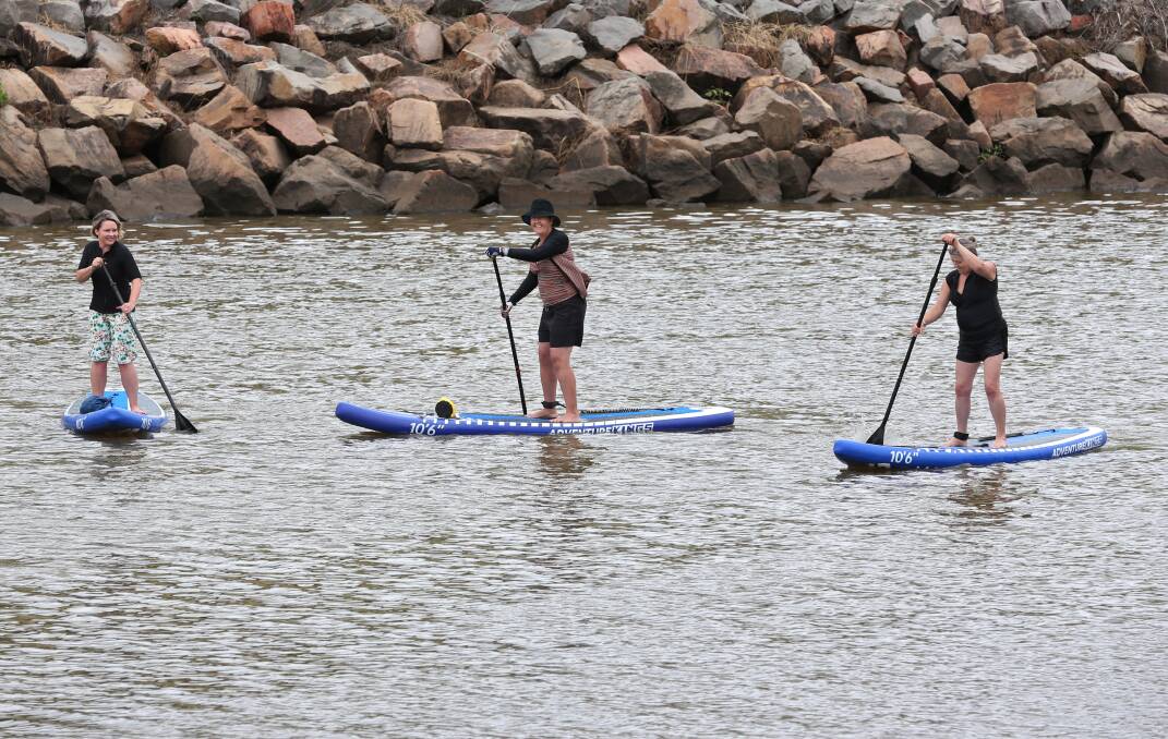 WASSUP: SUP Sistas Kate McLaughlin, Cindy Cawsey and Gwen Teasdale on the Hunter River at Maitland. PICTURE: Simone De Peak.