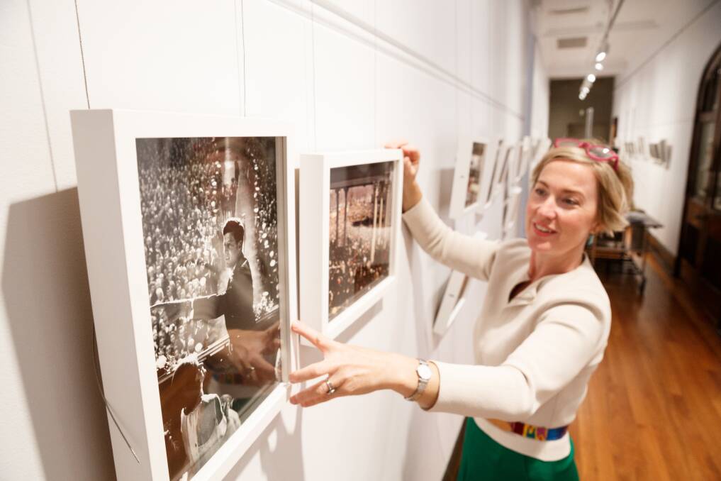DEBUT: Gallery director Brigette Uren with images from the new exhibit. Pictures: Max Mason-Hubers