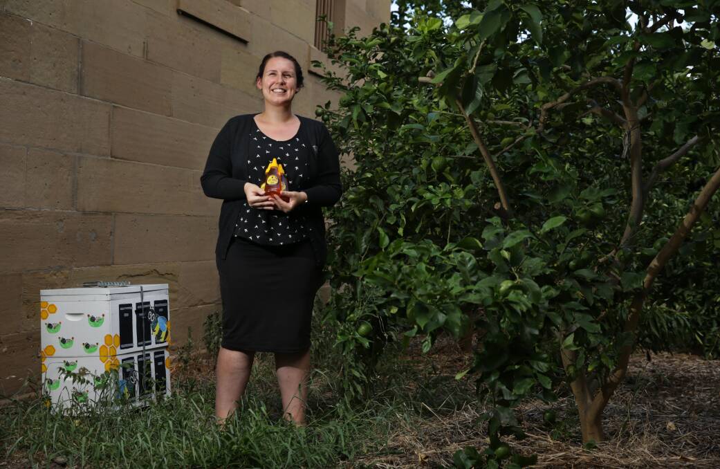 BUSY BEES: Maitland Gaol's service delivery officer Zoe Whiting with the site's bee hive, which has had its most successful harvest of six kilograms. Picture: Simone De Peak