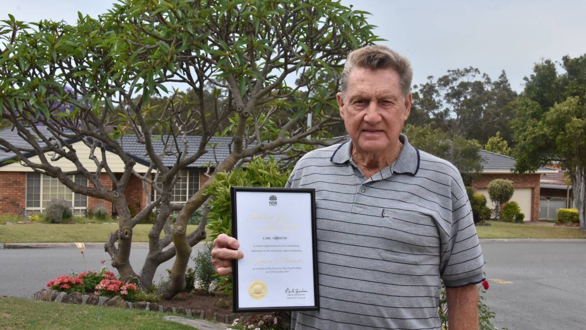 AWARD: Ashtonfield resident Carl Christie was recognised for his service as a justice of the peace, with a special certificate. Picture: Meg Francis
