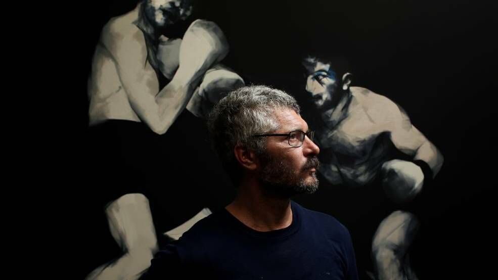  New work: Newcastle artist Nigel Milsom with one of his five new boxing artworks. Picture: Simone De Peak