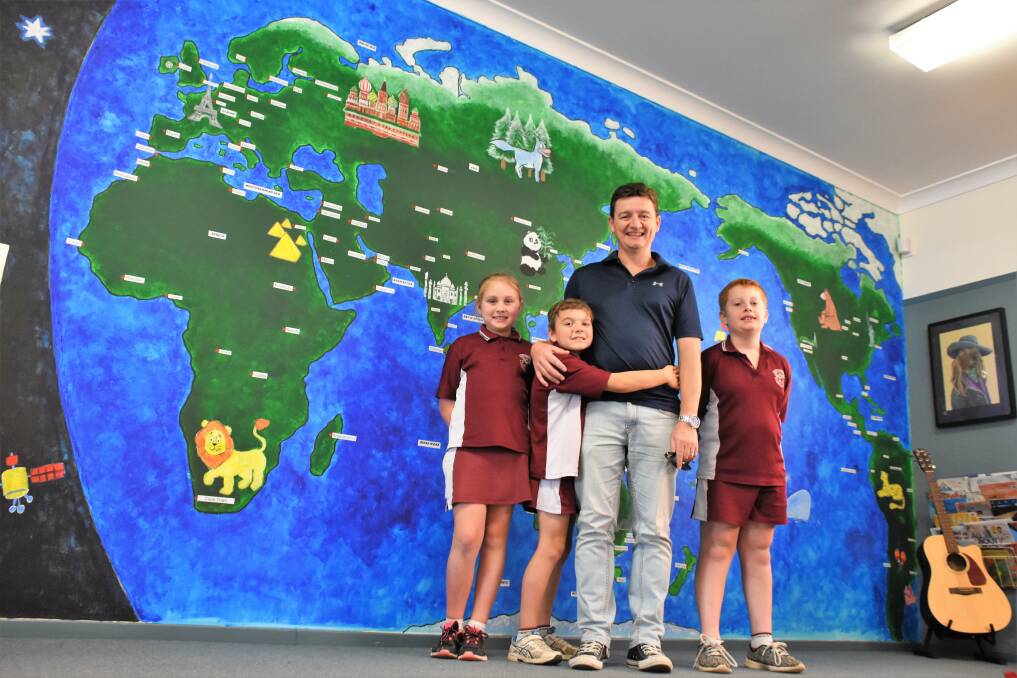 EXPRESSION: Artist James Brennan and students from St Paul's Primary School with the new mural. 