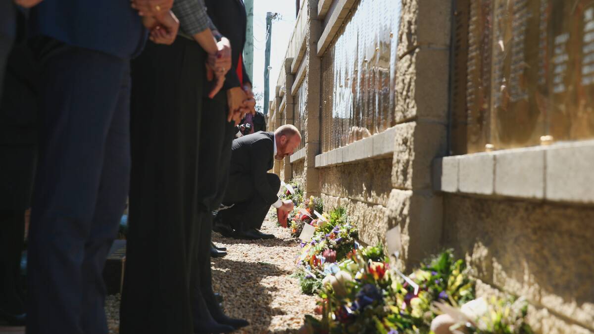 TRIBUTE: Wreaths were laid at the Jim Comerford memorial wall on Sunday. 